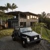 Electrified 73' VW Thing in front of LifeEdited:Maui as the sun goes down. Peanut groundcover and Papaya trees by Evan Ryan at Pono Grown. Cantilevered stairs by Hawaii Off-Grid. Windows by Andersen.